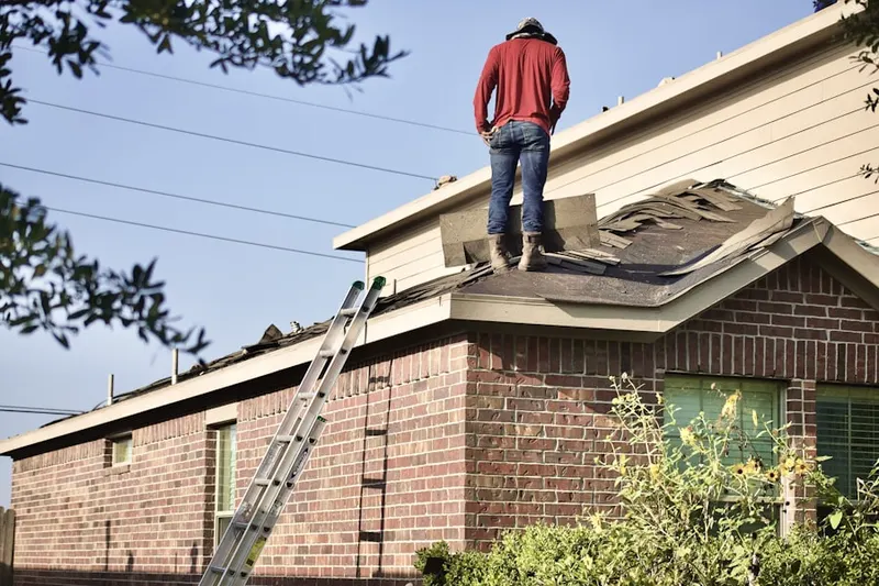 Professional roofer working on a residential roof in Stearns Park